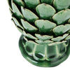 A close-up of a green ceramic artichoke ornament