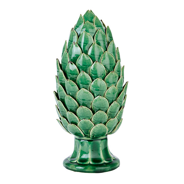 A green ceramic artichoke ornament on a white background