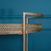 Close-up of a gold metal bar cart with a sleek frame