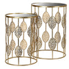 Two gold side tables with leaf designs and glass top, part of a nest of tables