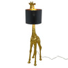 A golden giraffe floor lamp with a black shade on a white background