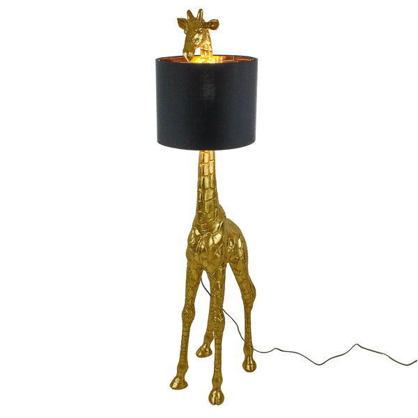 A golden giraffe floor lamp with a black shade on a white background