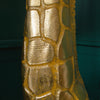 Close-up of a golden giraffe floor lamp