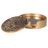 A set of four leopard print coasters with gold rims and a gold case