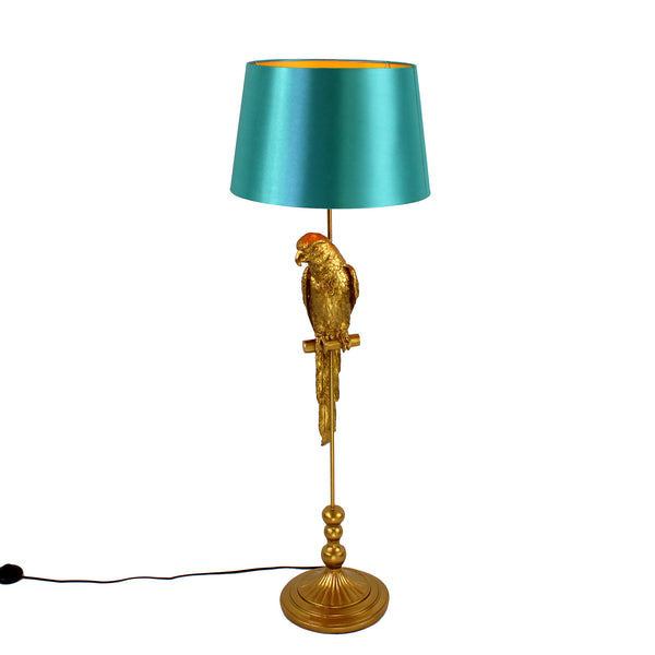 A golden parrot floor lamp with a turquoise shade on a white background