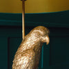 Close-up of a golden parrot floor lamp