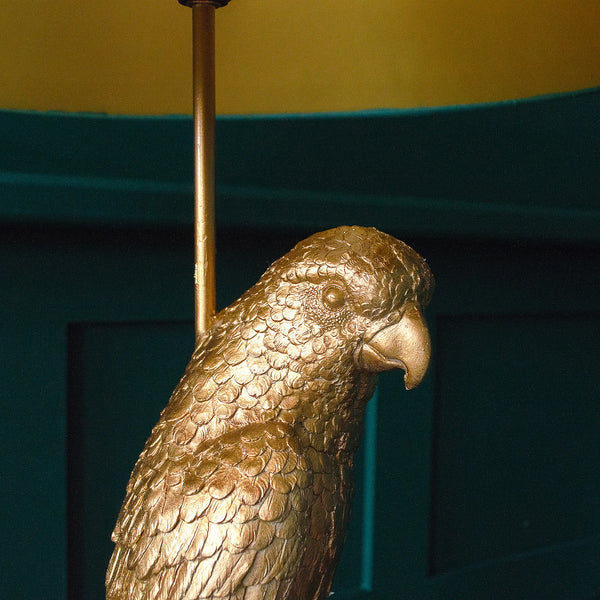 Close-up of a golden parrot floor lamp