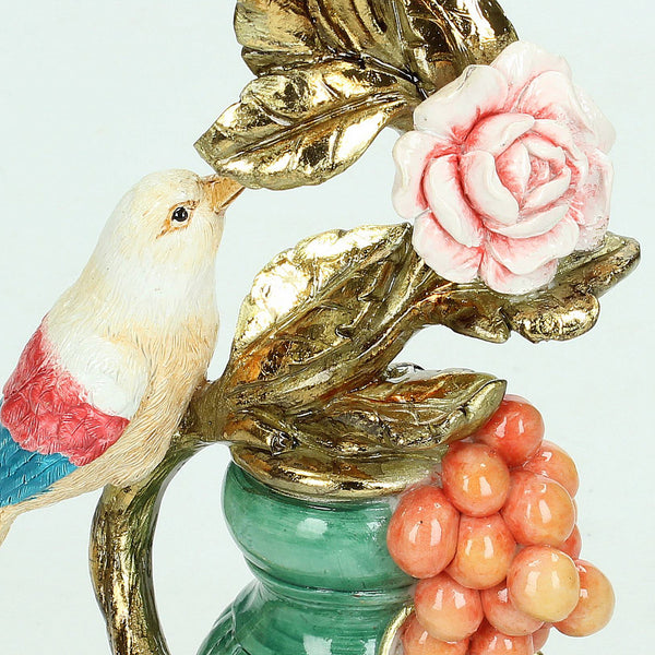 Close-up of a perching bird candle holder with a floral design