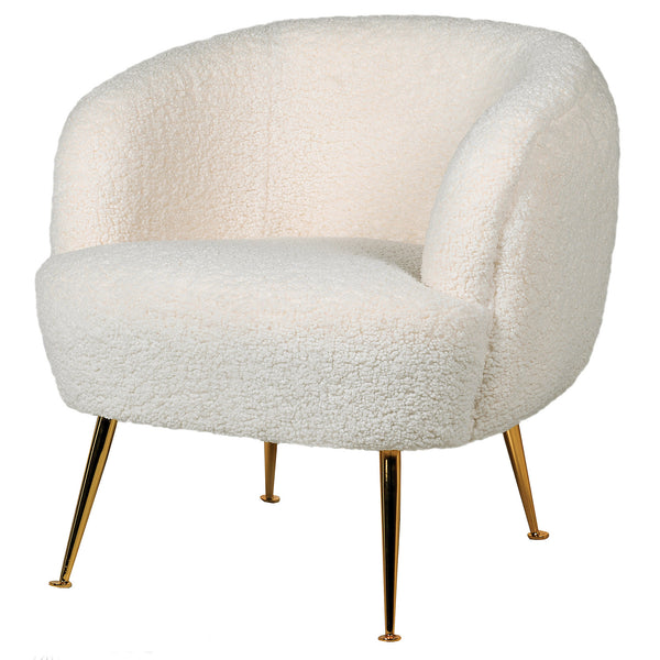 A white armchair with gold legs and a sheepskin upholstered seat